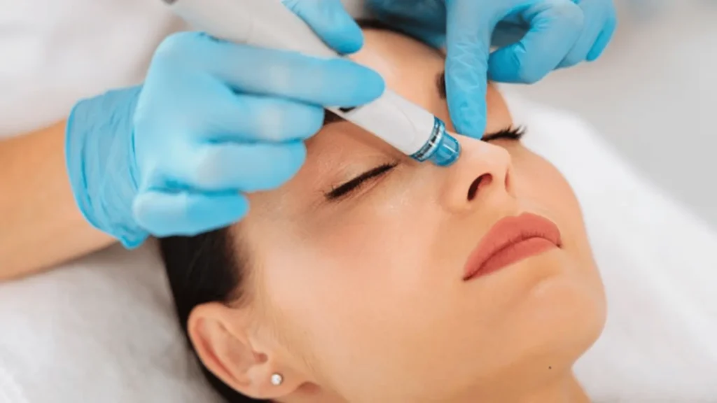 Client receiving a Hydra Facial treatment for deep cleansing, hydration, and glowing skin.